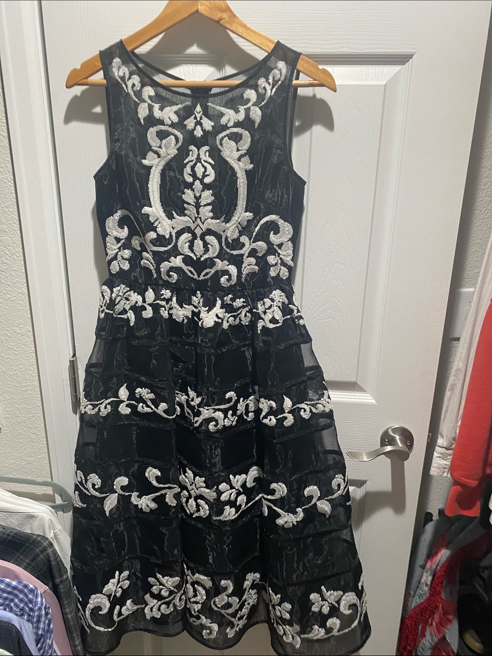 Bebe sleeveless black organza dress featuring white floral embroidery US 4
